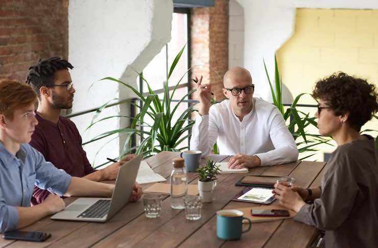 During a strategy meeting, team members actively collaborate and exchange organizational knowledge, utilizing shared expertise to enhance project outcomes and drive innovation.